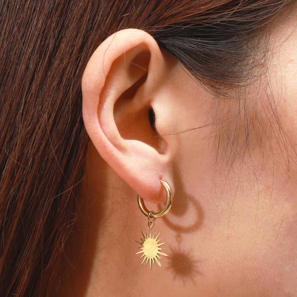 Reagan gold sunburst star dangle huggie hoop earrings
