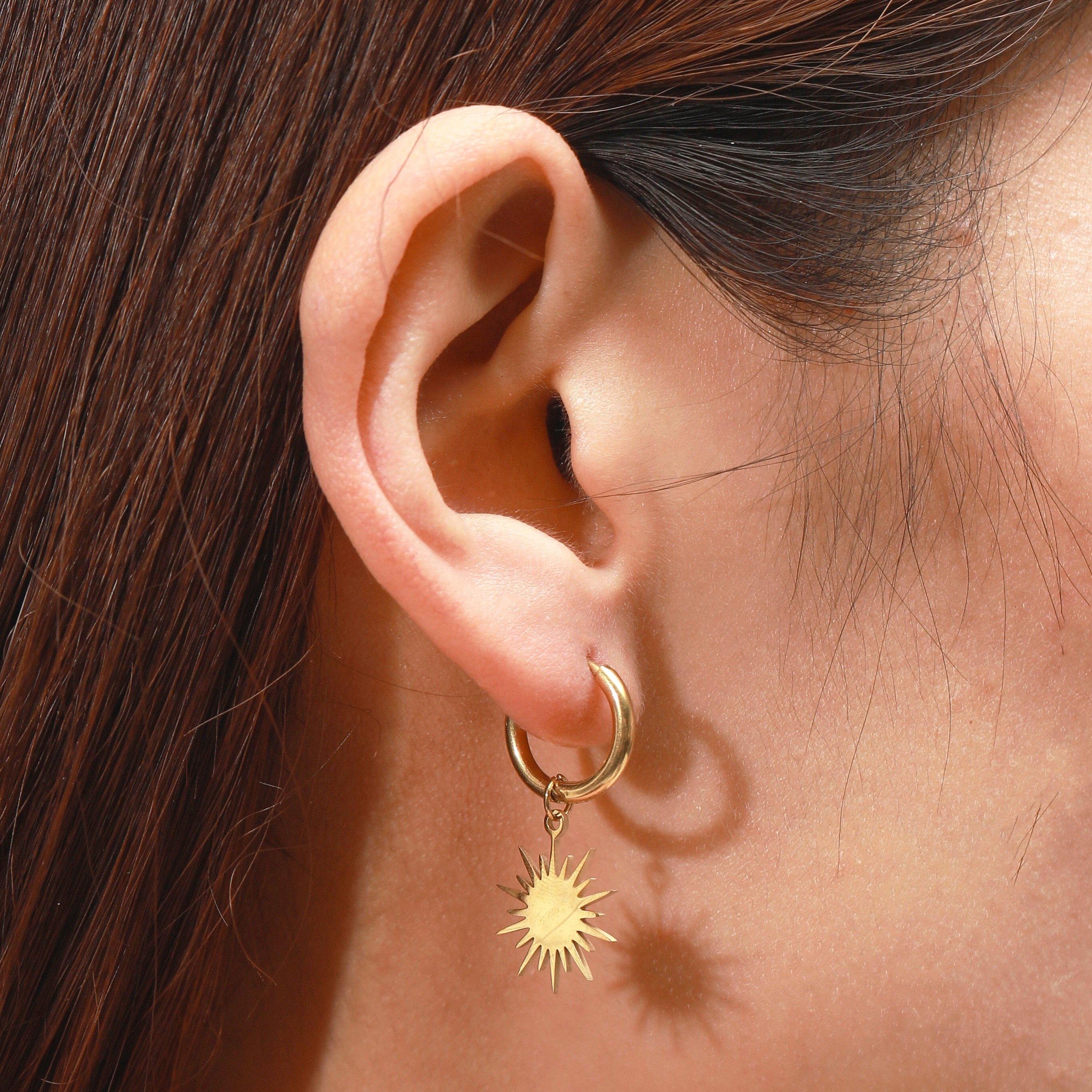 Reagan gold sunburst star dangle huggie hoop earrings