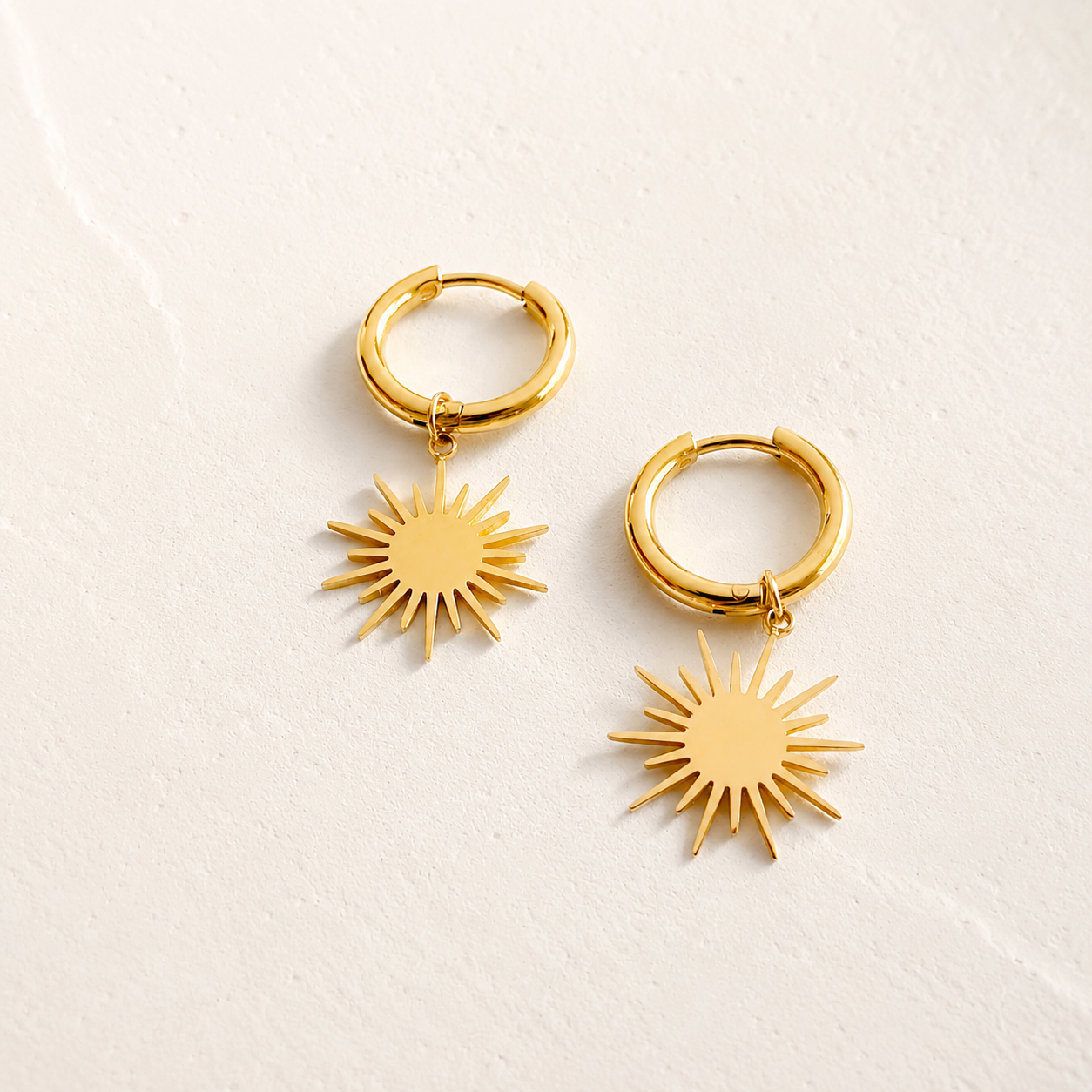 Reagan gold sunburst star dangle huggie hoop earrings