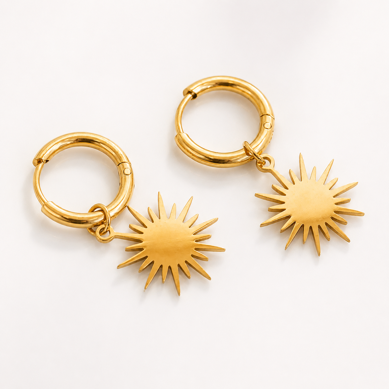 Reagan gold sunburst star dangle huggie hoop earrings