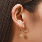 Reagan gold sunburst star dangle huggie hoop earrings